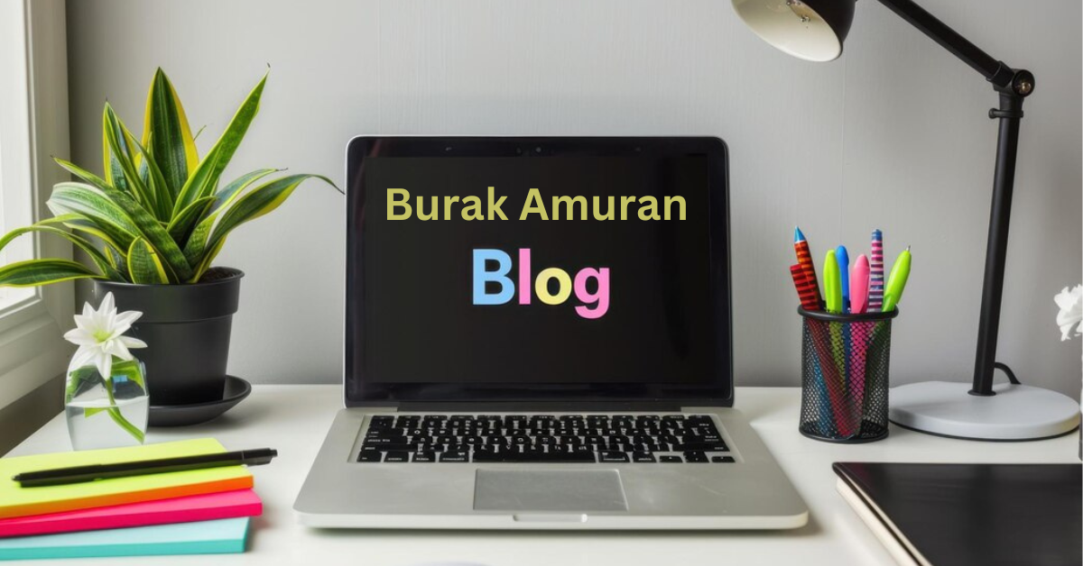 Burak Amuran smiling while working on his laptop in a cozy workspace